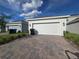 Two car garage with brick paver driveway at 11328 Listening Dr, Orlando, FL 32832