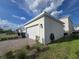 Two car garage featuring a spacious driveway and well-maintained lawn at 11328 Listening Dr, Orlando, FL 32832