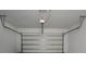 Clean, white garage interior featuring a modern garage door and operating mechanism at 11328 Listening Dr, Orlando, FL 32832