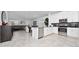 Stylish kitchen with stainless appliances, white cabinets, and tile flooring, leading into the living area at 11328 Listening Dr, Orlando, FL 32832