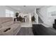 An open-concept living room boasts tile flooring, a staircase, and flows into the dining and kitchen areas at 11328 Listening Dr, Orlando, FL 32832