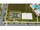 Aerial view of community basketball and sand volleyball courts, meticulously maintained and ready for play at 11328 Listening Dr, Orlando, FL 32832