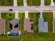 Overhead view showing rooftops and lawns with driveways, showcasing neighboring houses, including one with a private pool at 1158 Legatto Loop, Dundee, FL 33838