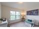 Home office or bedroom with a large window, desk, and modern decor at 1158 Legatto Loop, Dundee, FL 33838