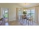 Bright dining area featuring a modern table and chairs, adjacent to the living room at 1158 Legatto Loop, Dundee, FL 33838