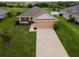 Charming single-story home featuring a well-manicured lawn and an attached two-car garage at 1158 Legatto Loop, Dundee, FL 33838