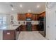 Well lit kitchen featuring dark wood cabinetry, granite countertops and stainless steel appliances at 1158 Legatto Loop, Dundee, FL 33838