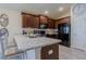 Modern kitchen with dark wood cabinetry, granite countertops, and stainless steel appliances at 1158 Legatto Loop, Dundee, FL 33838