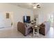 Relaxing living room with a media center and comfortable seating, leading to a bright dining space at 1158 Legatto Loop, Dundee, FL 33838