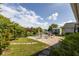 Landscaped backyard with a brick patio, fenced yard, and lush greenery, ideal for outdoor entertaining and relaxation at 121 White Birch Dr, Kissimmee, FL 34743