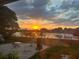 Backyard patio with lake sunset views, providing a perfect backdrop for outdoor relaxation and entertaining at 121 White Birch Dr, Kissimmee, FL 34743