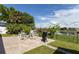 A patio with outdoor furniture and a grill overlooks a lake, perfect for enjoying scenic waterfront views and outdoor cooking at 121 White Birch Dr, Kissimmee, FL 34743