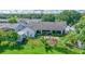 Aerial view of backyard featuring patio, screened porch, lush green space and a storage shed, creating the perfect outdoor retreat at 121 White Birch Dr, Kissimmee, FL 34743