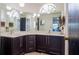 Bathroom features lots of cabinets, dual sinks, a unique mirror and lots of light at 121 White Birch Dr, Kissimmee, FL 34743