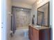Bathroom features marble tiled shower, warm cabinet and granite sink at 121 White Birch Dr, Kissimmee, FL 34743