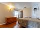 Bedroom boasts hard wood floors, a dresser and warm lighting at 121 White Birch Dr, Kissimmee, FL 34743