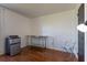 Minimalist bedroom setup with hard wood floors, stainless steel table and mini fridge at 121 White Birch Dr, Kissimmee, FL 34743