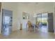 Light filled dining room features unique chandelier, floor to ceiling window and modern finishes at 121 White Birch Dr, Kissimmee, FL 34743