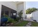 Exterior view of the house showcasing the screened-in patio, siding, and hardscape walkway at 121 White Birch Dr, Kissimmee, FL 34743