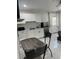 Bright kitchen with white cabinets, stainless steel refrigerator, and dining table for a practical living space at 121 White Birch Dr, Kissimmee, FL 34743