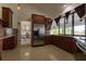 Kitchen with wooden cabinets, stainless steel appliances and an open view to dining area at 121 White Birch Dr, Kissimmee, FL 34743