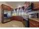 Kitchen with wooden cabinets, stainless steel appliances and a large window overlooking greenery at 121 White Birch Dr, Kissimmee, FL 34743