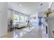 Bright living room featuring tile floors, a white sofa, and fireplace at 121 White Birch Dr, Kissimmee, FL 34743