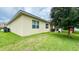 Spacious backyard with lush green grass and mature tree providing shade at 1222 Yorkshire Ct, Davenport, FL 33896