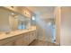 Modern bathroom with double vanity, white cabinets, quartz countertops, and a large glass-enclosed shower at 1222 Yorkshire Ct, Davenport, FL 33896