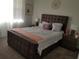 Comfortable bedroom featuring neutral tones and a modern upholstered bed frame at 1222 Yorkshire Ct, Davenport, FL 33896