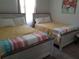 Shared bedroom featuring two twin beds and natural light at 1222 Yorkshire Ct, Davenport, FL 33896