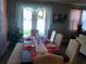 Elegant dining room featuring a beautifully set table with a chandelier above, and a view of the backyard at 1222 Yorkshire Ct, Davenport, FL 33896