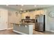 Modern kitchen featuring stainless steel appliances, granite countertops, breakfast bar seating, and overhead pendant lights at 1222 Yorkshire Ct, Davenport, FL 33896