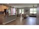 Bright open-plan living space featuring tile floors, modern light fixtures, sofas and adjacent dining area at 1222 Yorkshire Ct, Davenport, FL 33896