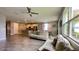 Bright open-concept living space featuring tile floors, modern kitchen, adjacent dining and a comfy sofa at 1222 Yorkshire Ct, Davenport, FL 33896