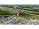 Beautiful aerial view capturing the neighborhood's serene environment with lush greenery and nearby highway at 1335 Greenfield Loop, Kissimmee, FL 34747