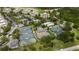 Aerial view showcases tennis courts, lush landscaping, and nearby condominiums at 1335 Greenfield Loop, Kissimmee, FL 34747