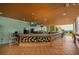 Outdoor bar area with counter seating and TVs for entertainment at 1335 Greenfield Loop, Kissimmee, FL 34747