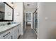 This bathroom offers granite countertops, modern fixtures, and a walk-in tiled shower with glass door at 1335 Greenfield Loop, Kissimmee, FL 34747