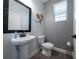 Stylish half bathroom featuring a pedestal sink, modern fixtures, and sleek design at 1335 Greenfield Loop, Kissimmee, FL 34747
