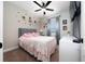 Charming bedroom featuring astronaut themed wall decorations, gray carpet, and a ceiling fan at 1335 Greenfield Loop, Kissimmee, FL 34747
