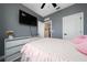 Comfortable bedroom features a ceiling fan, television and stylish dresser at 1335 Greenfield Loop, Kissimmee, FL 34747