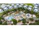 Fantastic aerial perspective highlighting the water park amenities, with its beautiful pool and palm trees at 1335 Greenfield Loop, Kissimmee, FL 34747