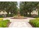 Beautiful courtyard with a large decorative fountain and mature landscaping at 1335 Greenfield Loop, Kissimmee, FL 34747