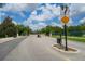 Gated community entrance with electronic access and well-maintained landscaping at 1335 Greenfield Loop, Kissimmee, FL 34747