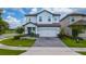 Charming two-story home with manicured lawn, flower beds, and a brick paver driveway at 1335 Greenfield Loop, Kissimmee, FL 34747