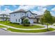 Charming two-story home with a lush green lawn, beautiful landscaping, and inviting curb appeal at 1335 Greenfield Loop, Kissimmee, FL 34747