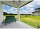 Relax on this front porch with a bench offering a great view of the lush front yard at 1335 Greenfield Loop, Kissimmee, FL 34747