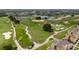 Scenic golf course view featuring lush fairways, tranquil ponds, and surrounding homes in the distance at 1335 Greenfield Loop, Kissimmee, FL 34747