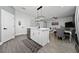 Open kitchen with an island, stylish pendant lighting, and a seamless transition to the living area at 1335 Greenfield Loop, Kissimmee, FL 34747